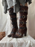 Brown leather knee high boots with buckles and faux fur trim