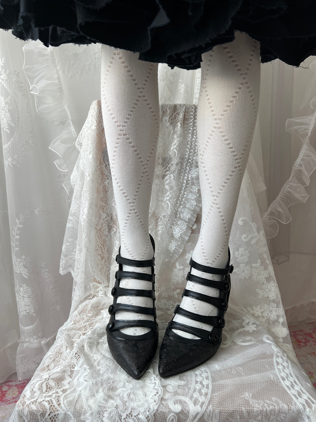 Black leather kitten heels with pointed toe and button details