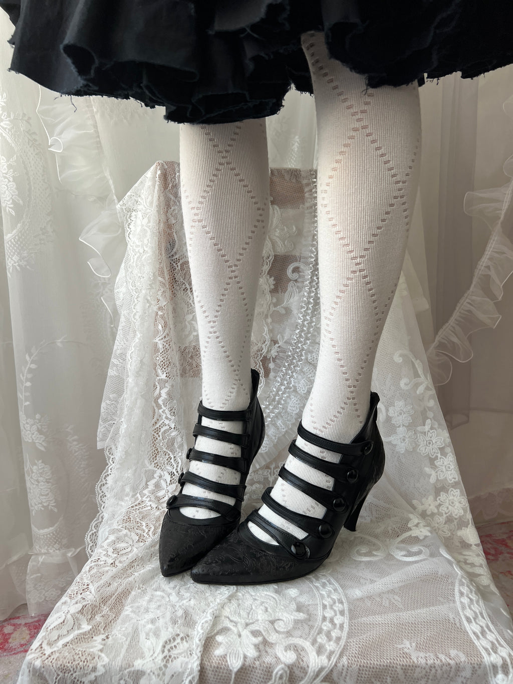 Black leather kitten heels with pointed toe and button details