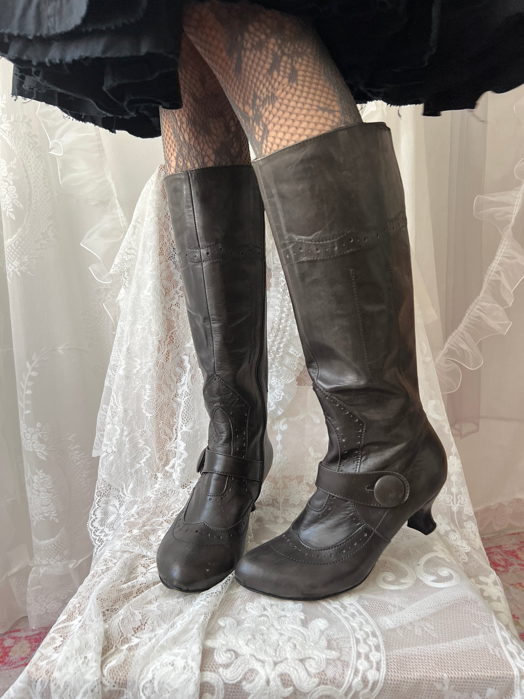 Black leather knee high boots with buckle detail