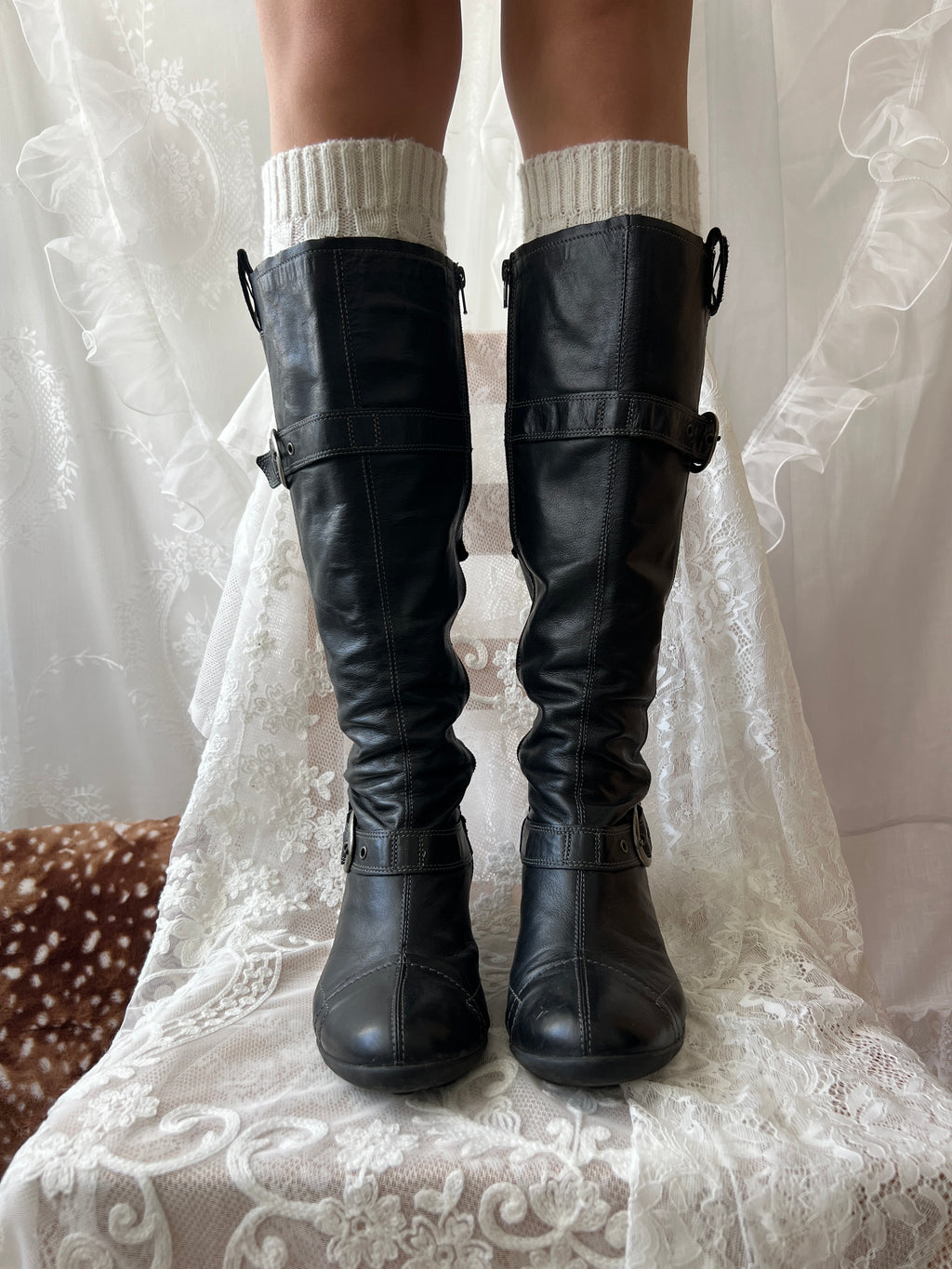 Black knee high boots with silver buckles
