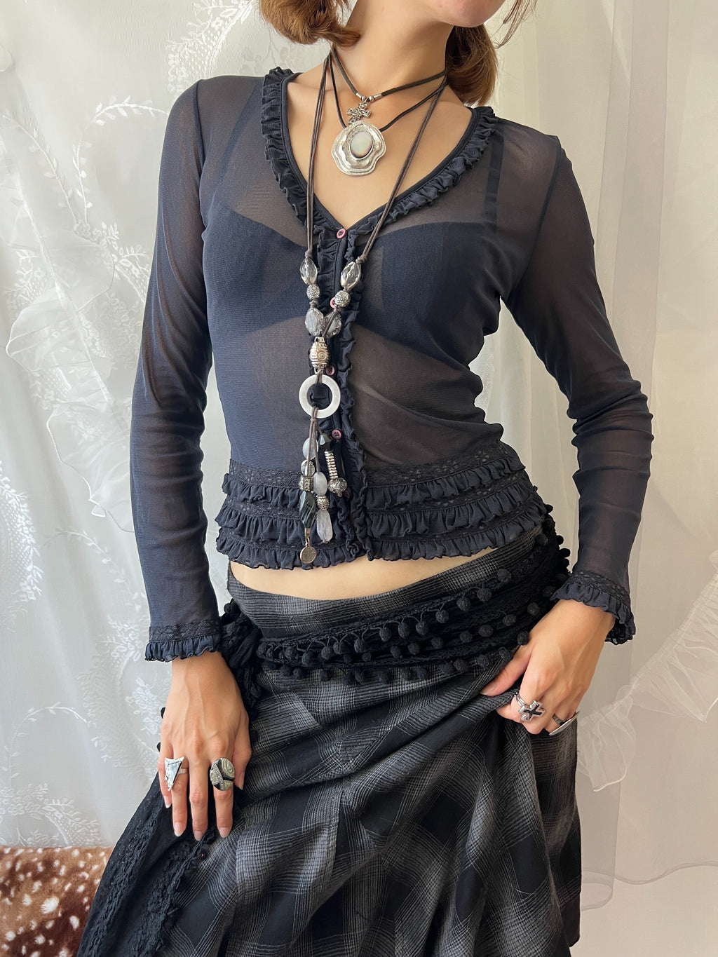 Dark blue sheer long sleeve top with ruffles and lace details