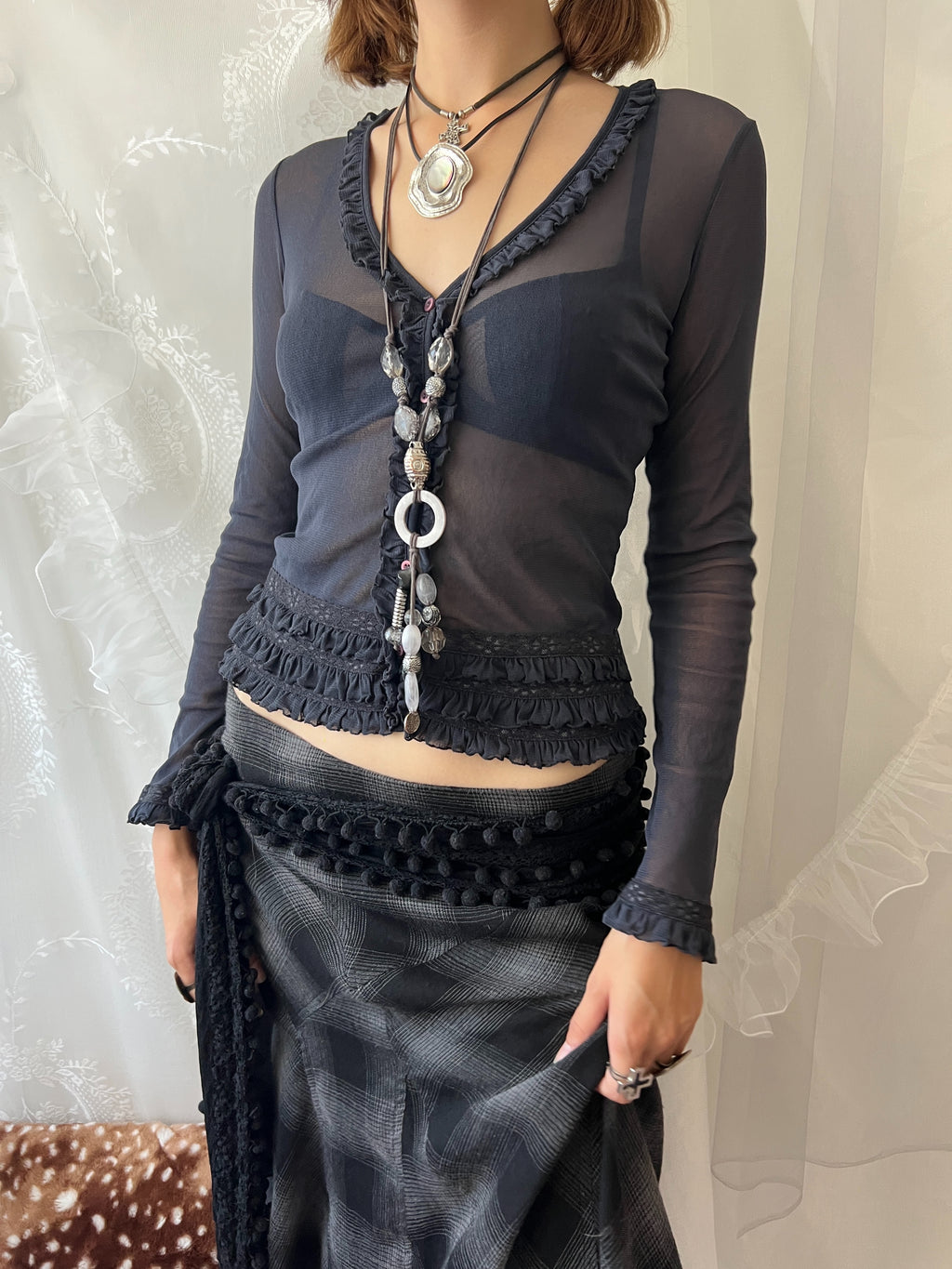 Dark blue sheer long sleeve top with ruffles and lace details