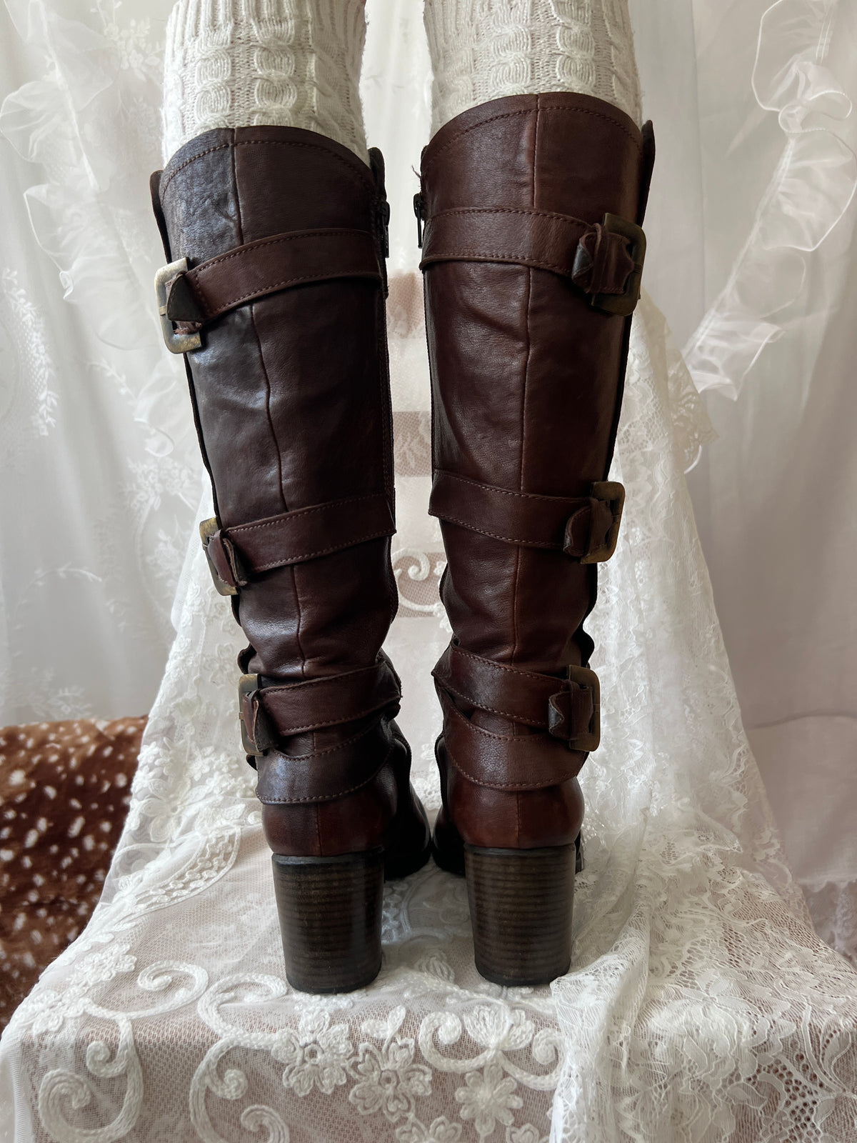 Brown knee high boots with buckle detail