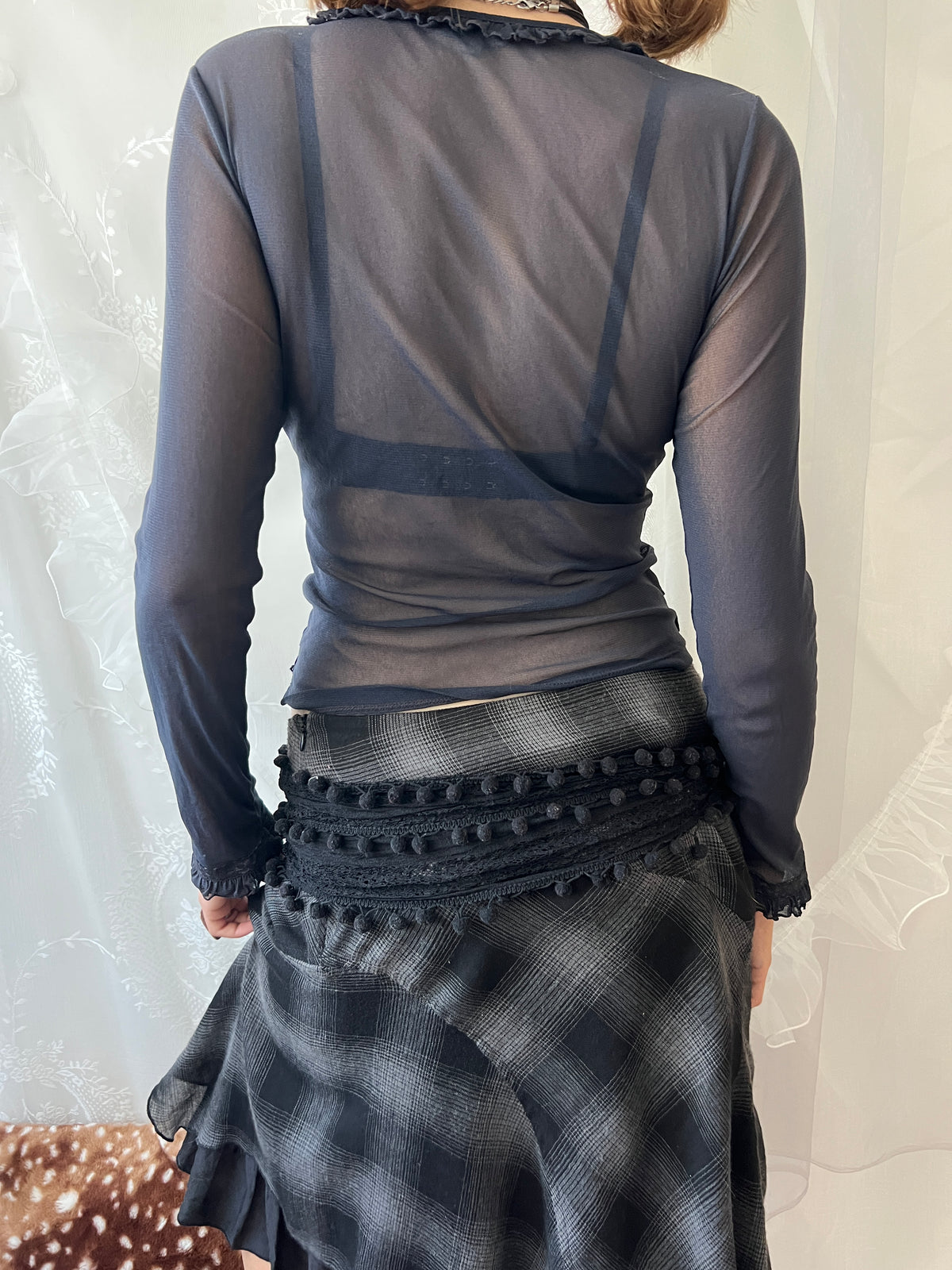 Dark blue sheer long sleeve top with ruffles and lace details