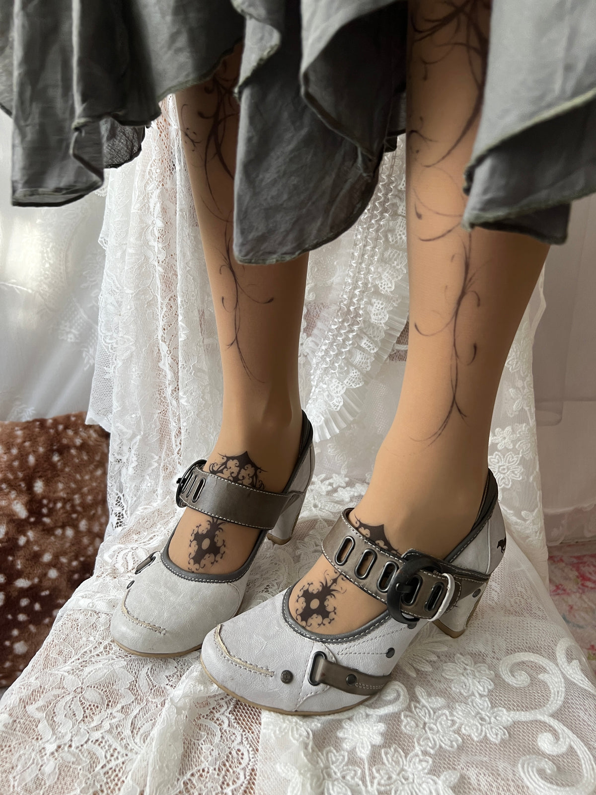 White Mustang heels with gray straps and buckles
