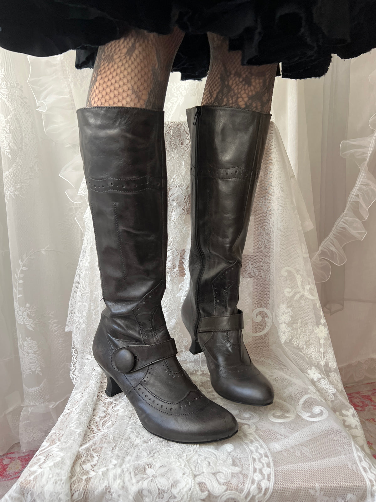Black leather knee high boots with buckle detail