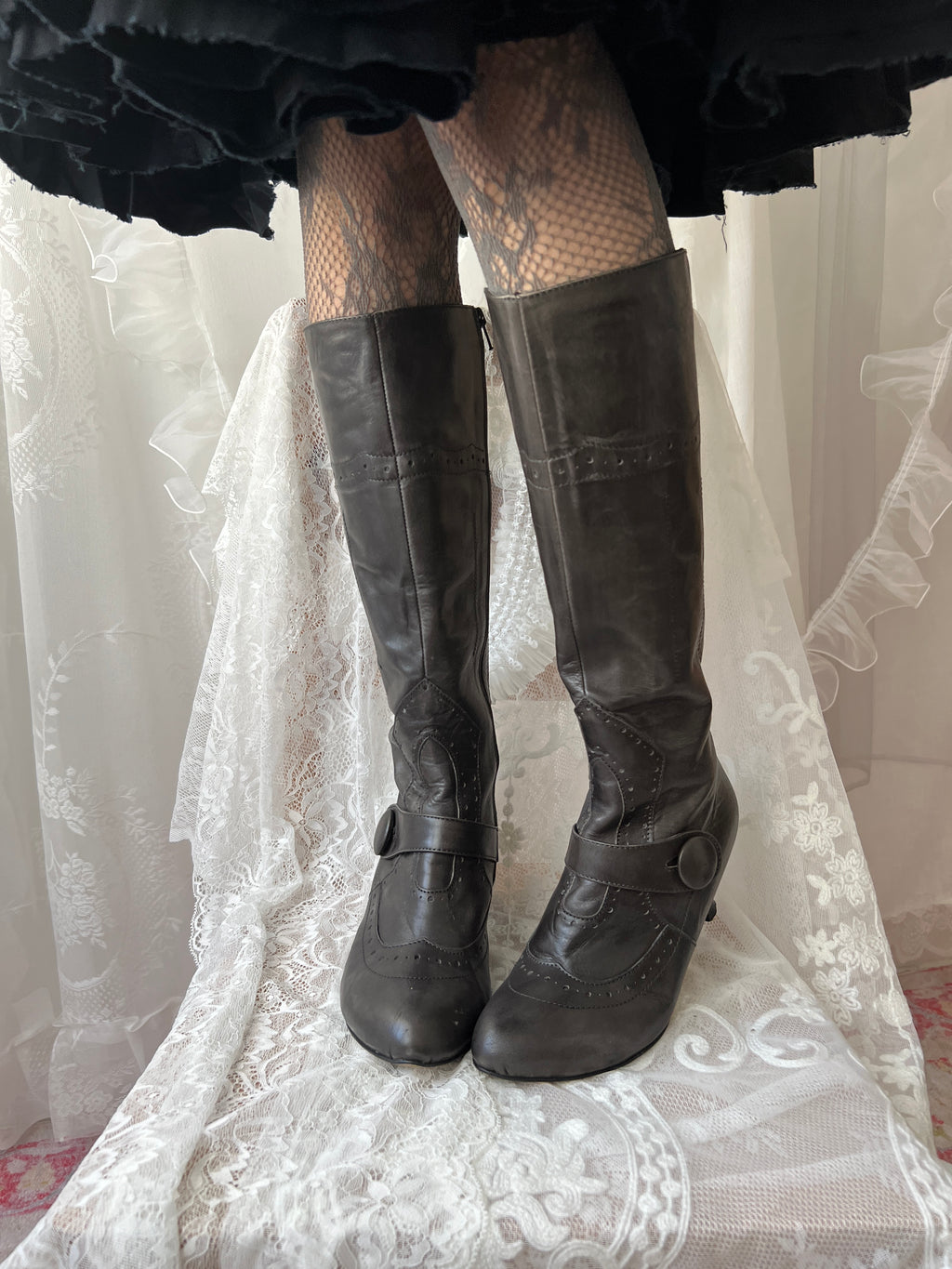 Black leather knee high boots with buckle detail