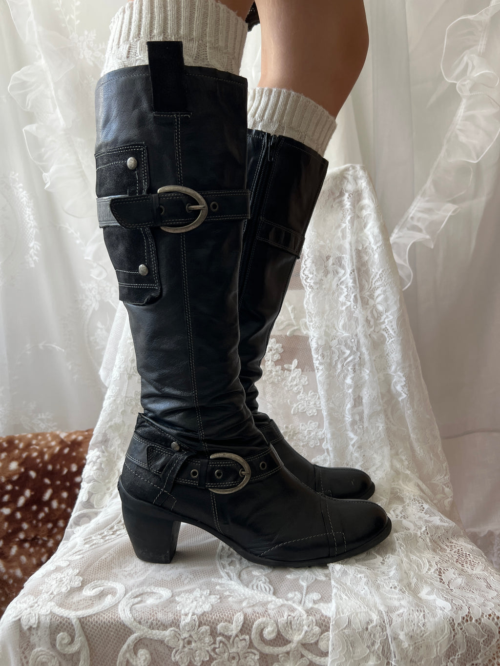 Black knee high boots with silver buckles