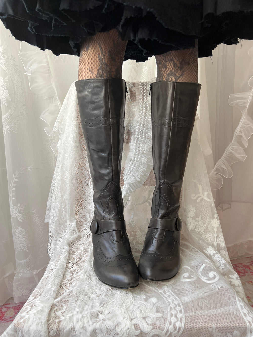 Black leather knee high boots with buckle detail