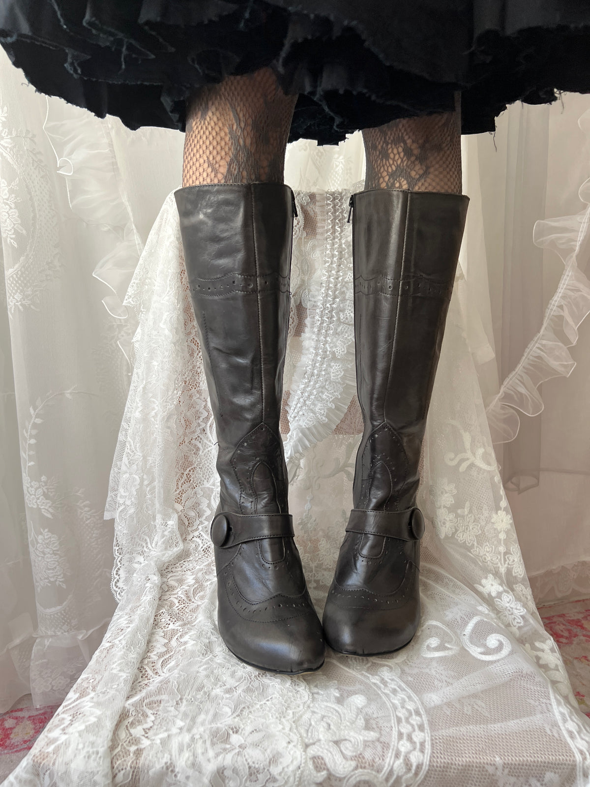 Black leather knee high boots with buckle detail