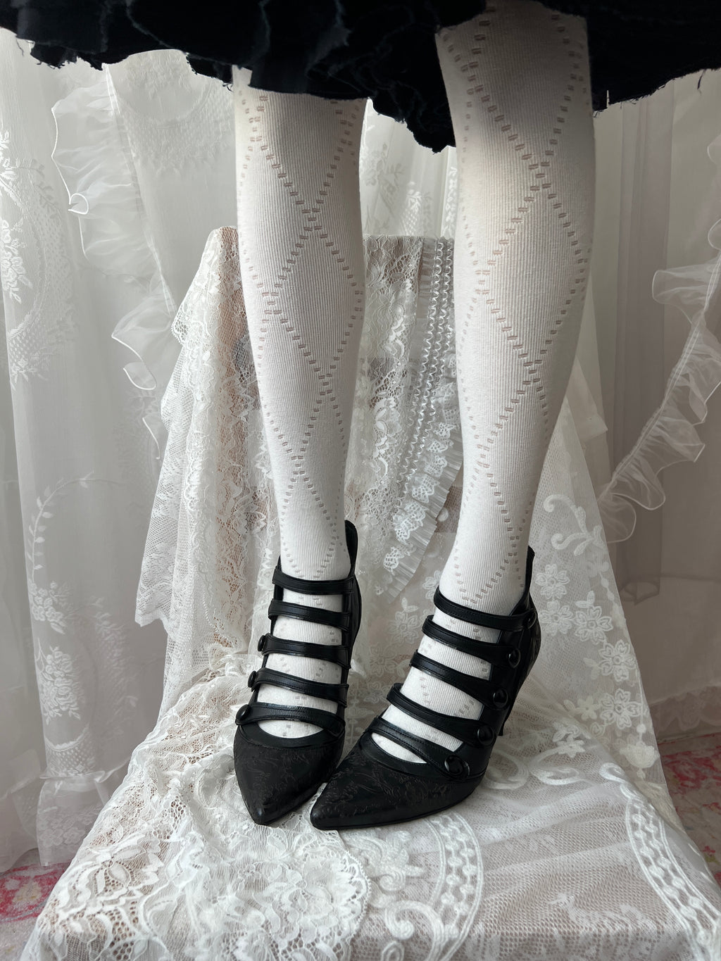 Black leather kitten heels with pointed toe and button details
