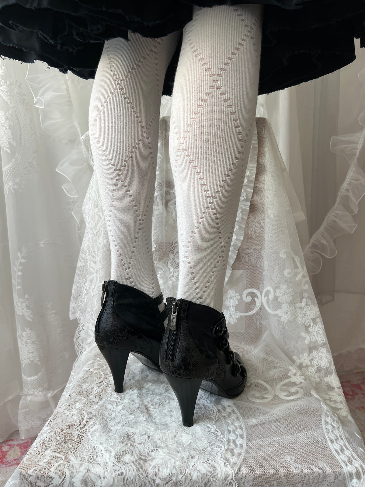 Black leather kitten heels with pointed toe and button details