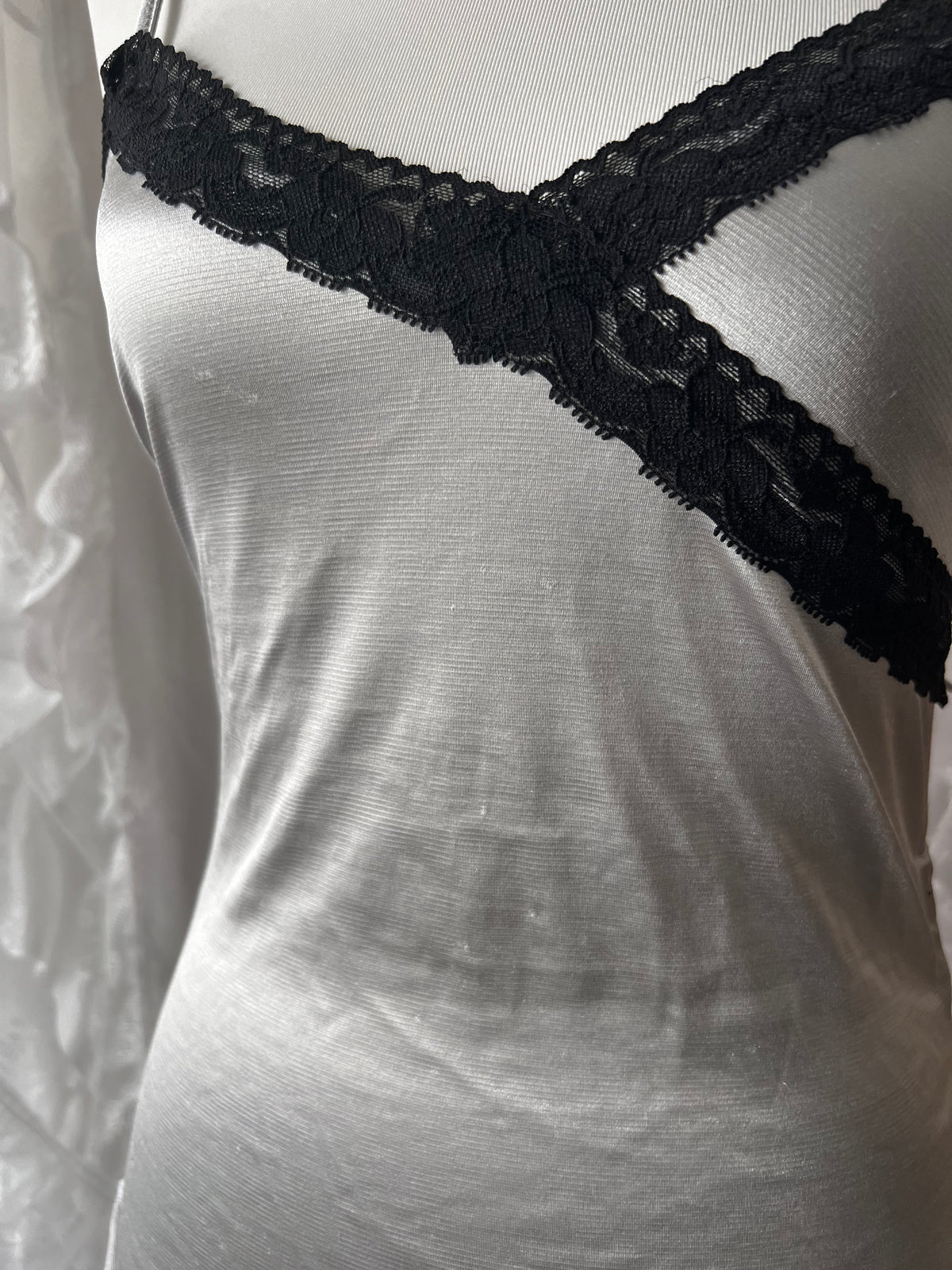 Black lace silver cami top with adjustable straps and tie detail