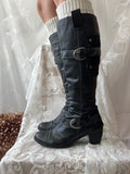 Black knee high boots with silver buckles