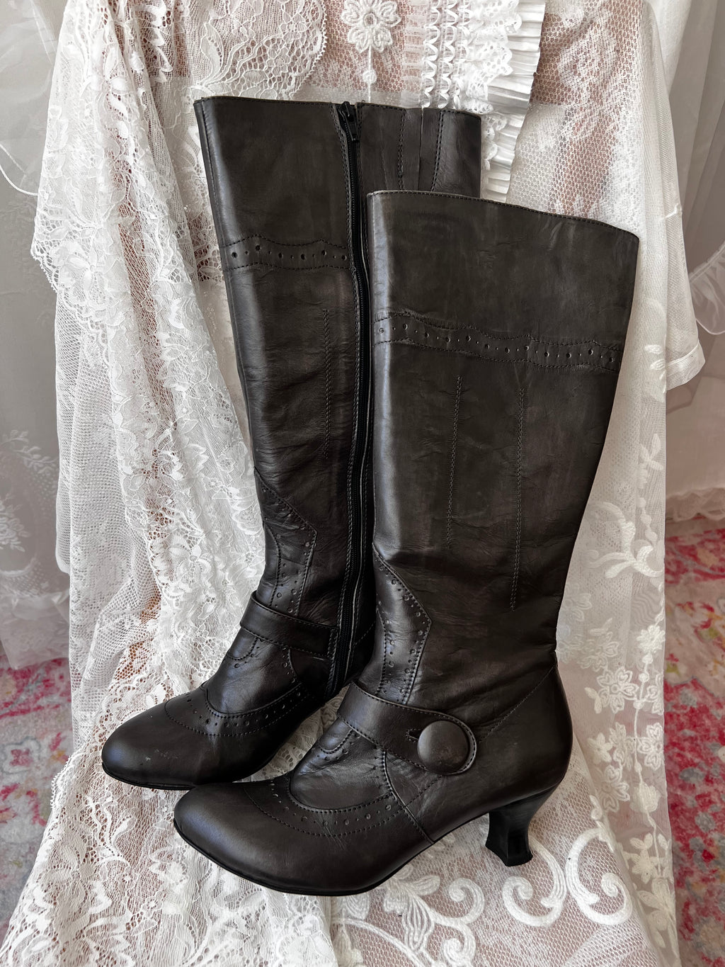 Black leather knee high boots with buckle detail
