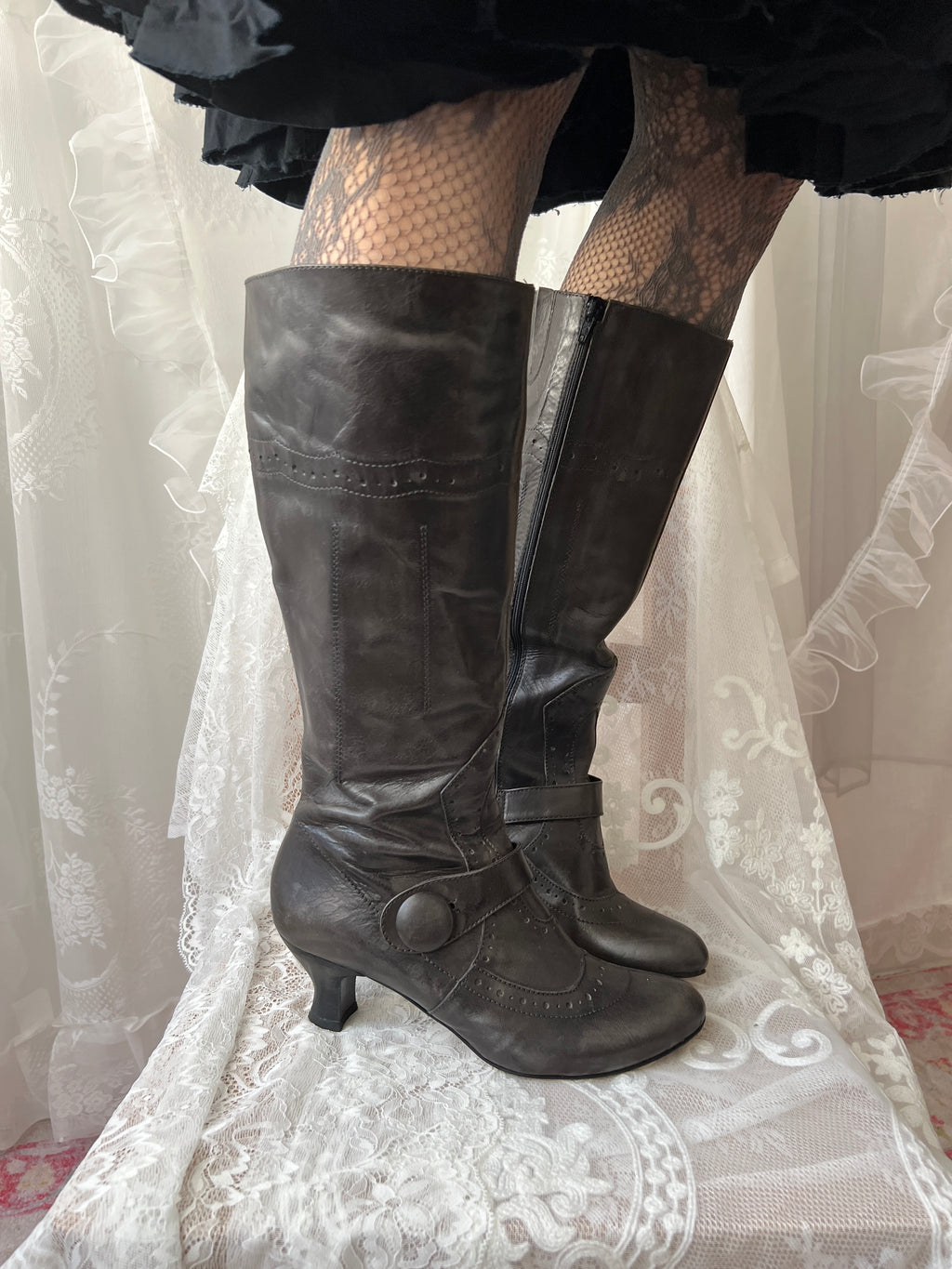 Black leather knee high boots with buckle detail