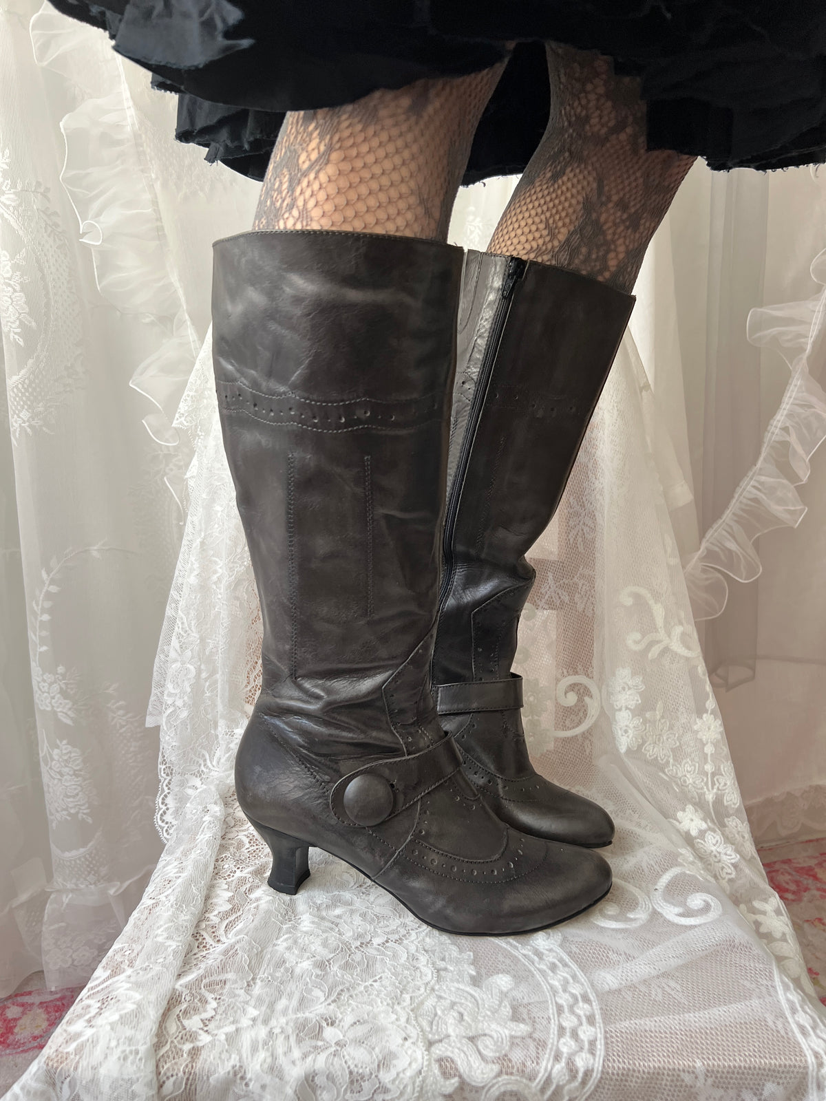 Black leather knee high boots with buckle detail