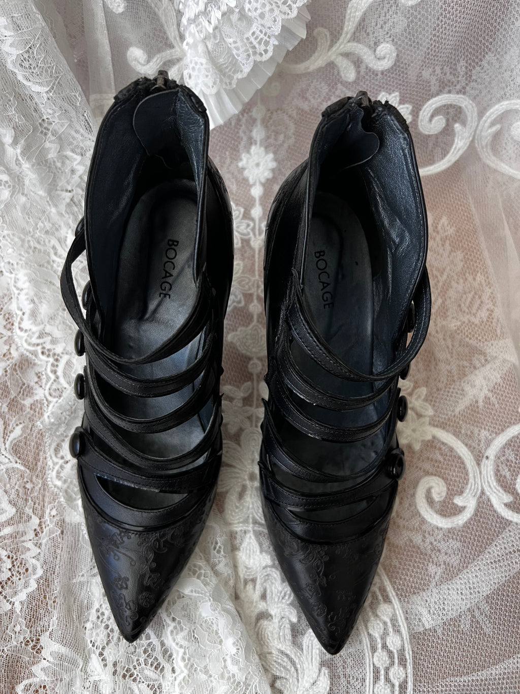Black leather kitten heels with pointed toe and button details