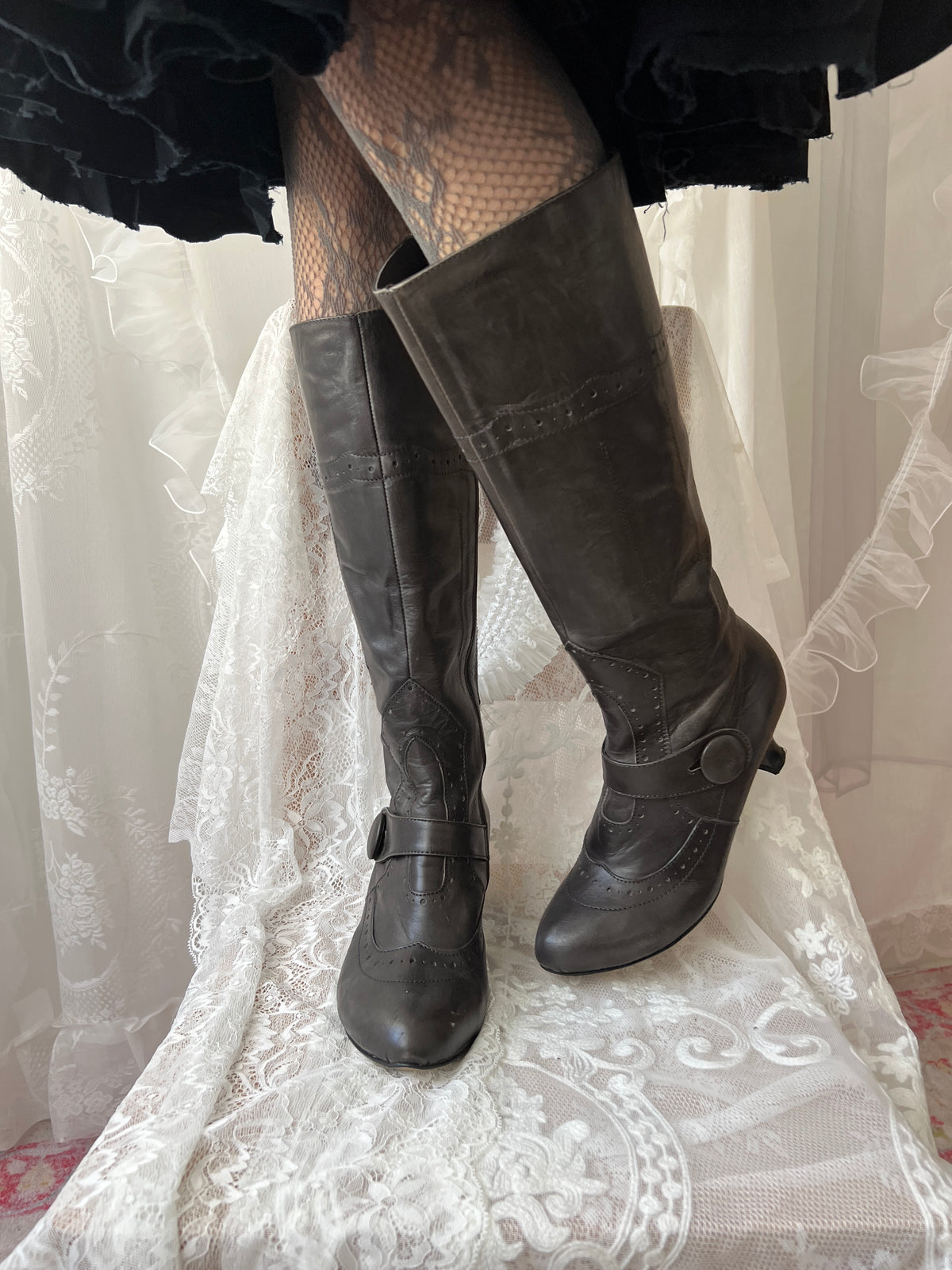 Black leather knee high boots with buckle detail