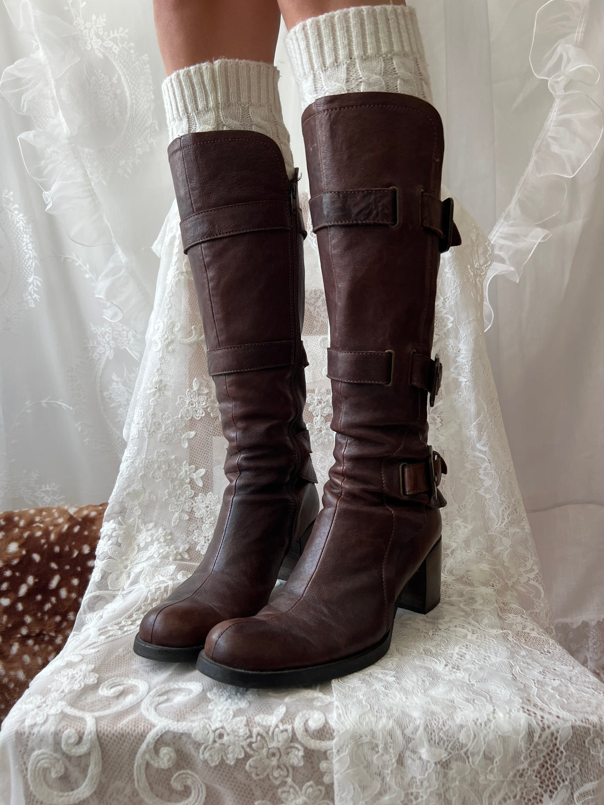Brown knee high boots with buckle detail