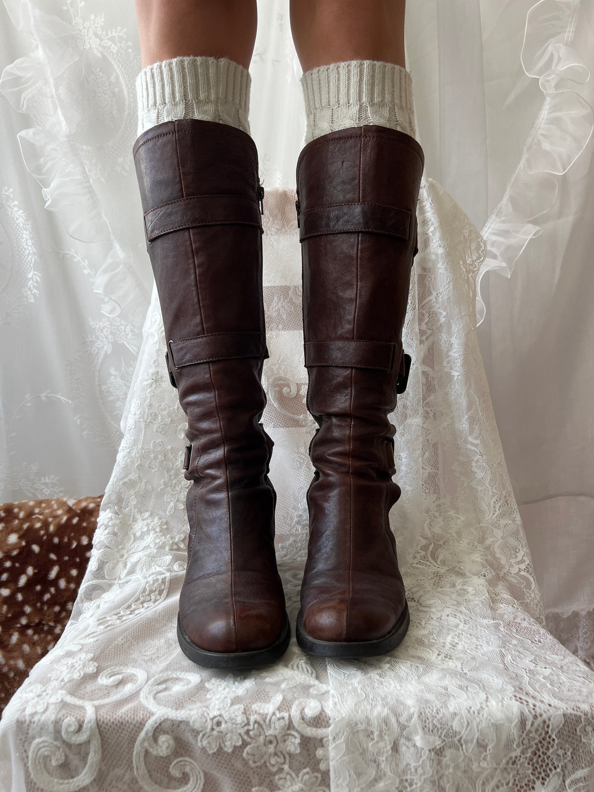 Brown knee high boots with buckle detail