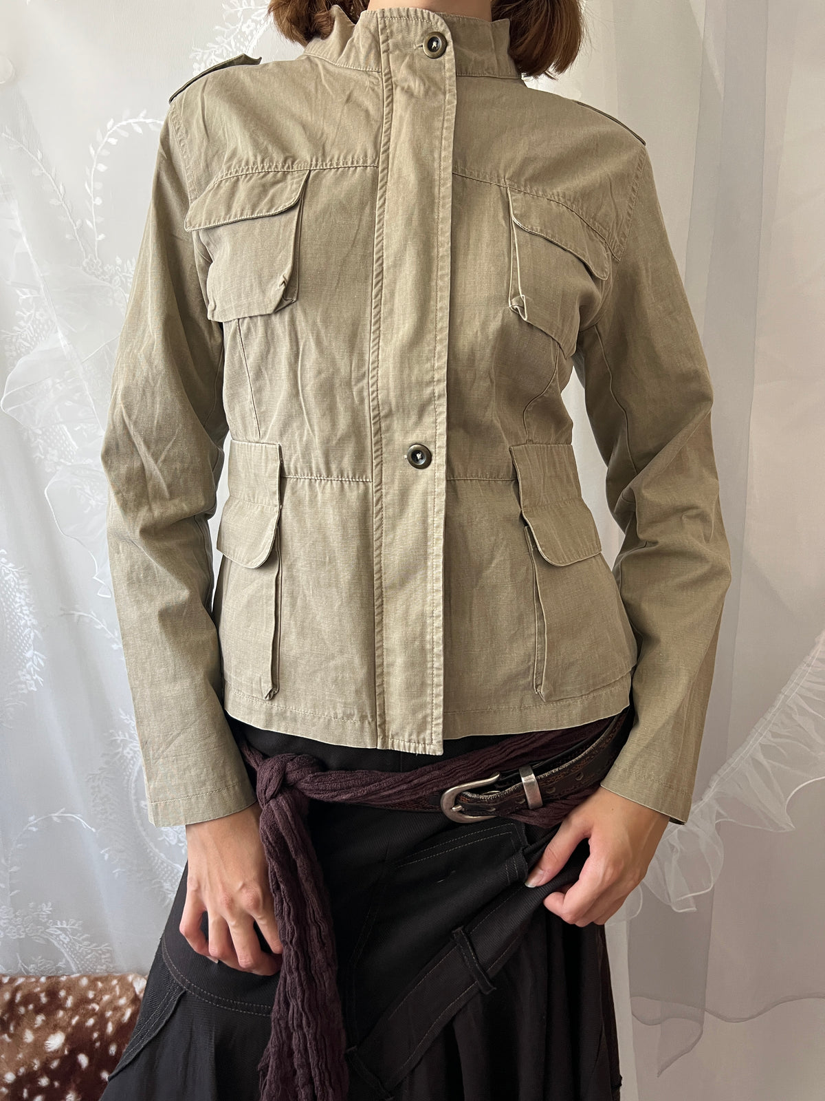 Khaki beige jacket with pockets, a zipper and a button-up front