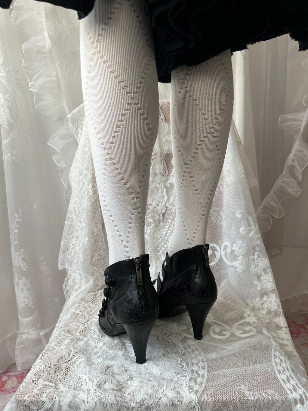 Black leather kitten heels with pointed toe and button details