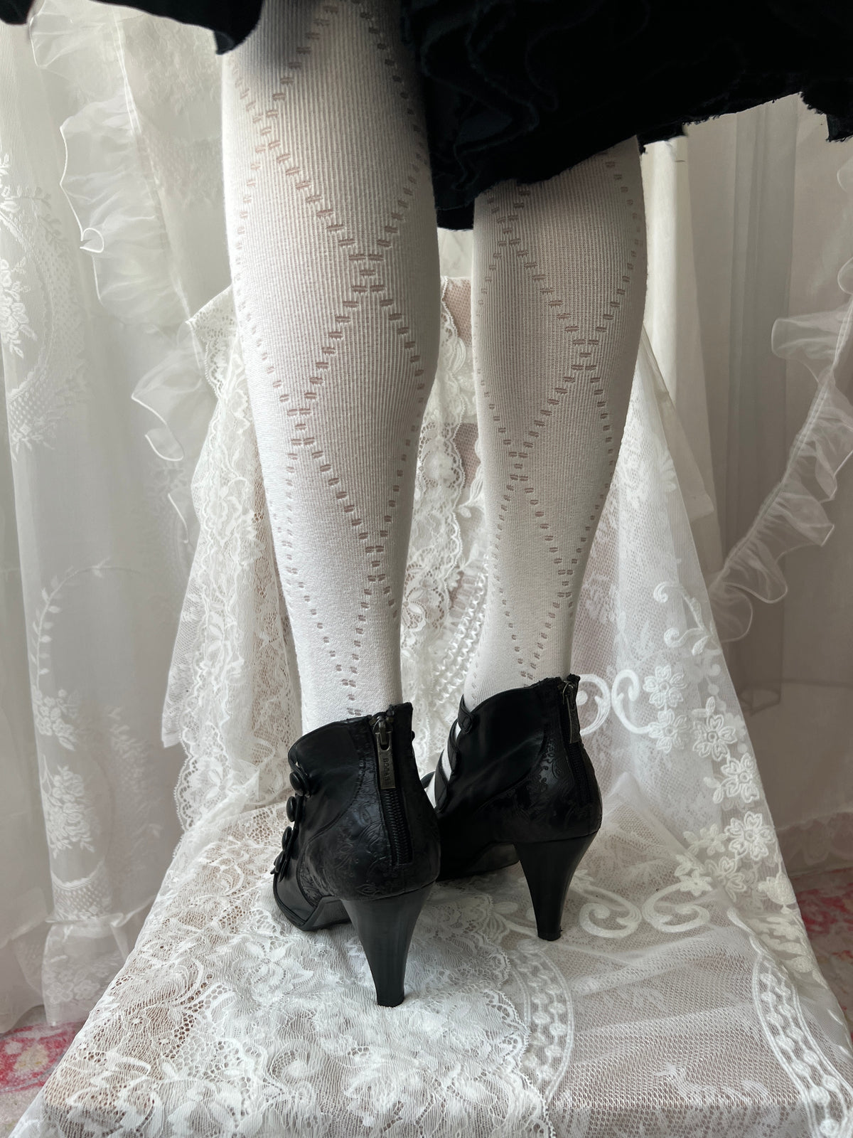 Black leather kitten heels with pointed toe and button details