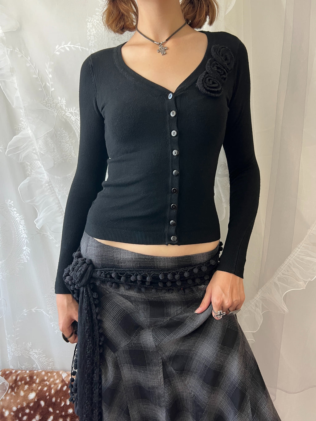 Black long sleeve top with button up front and flower detail