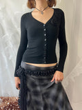Black long sleeve top with button up front and flower detail