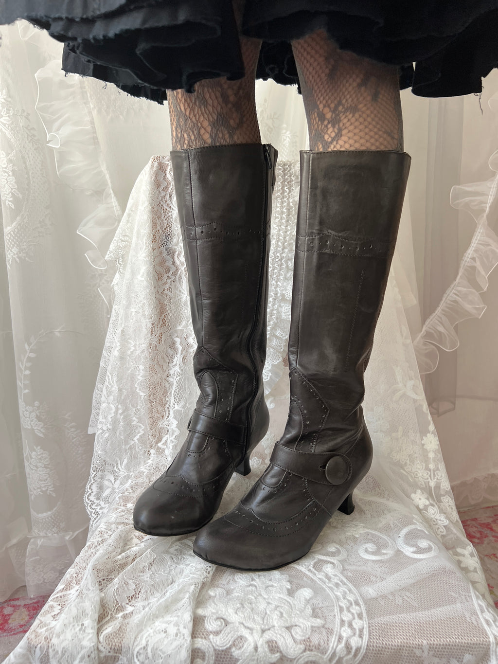 Black leather knee high boots with buckle detail