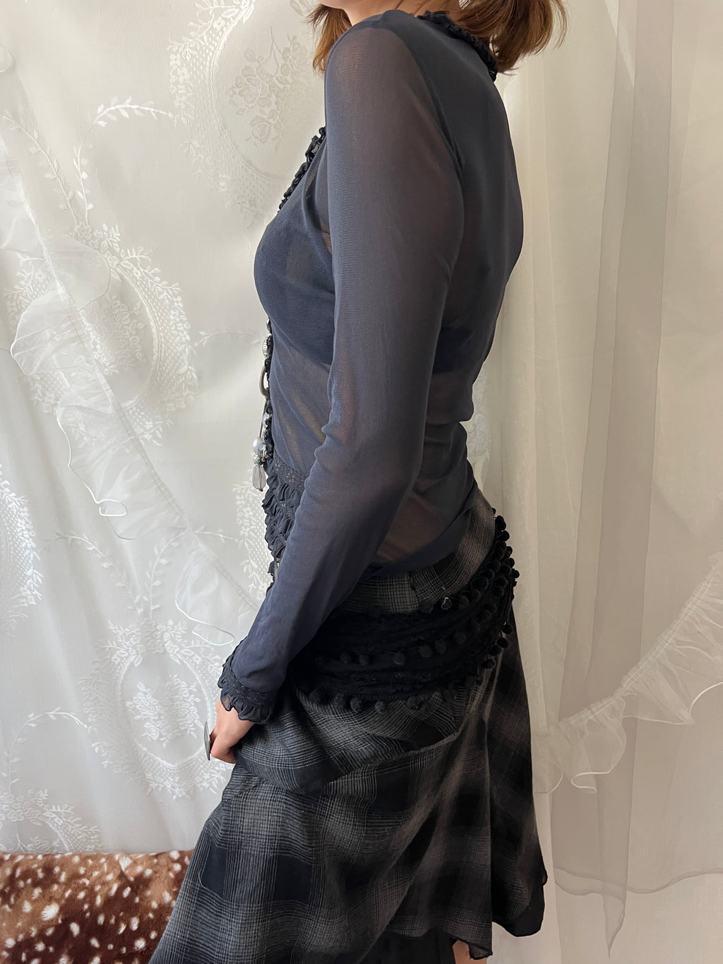 Dark blue sheer long sleeve top with ruffles and lace details