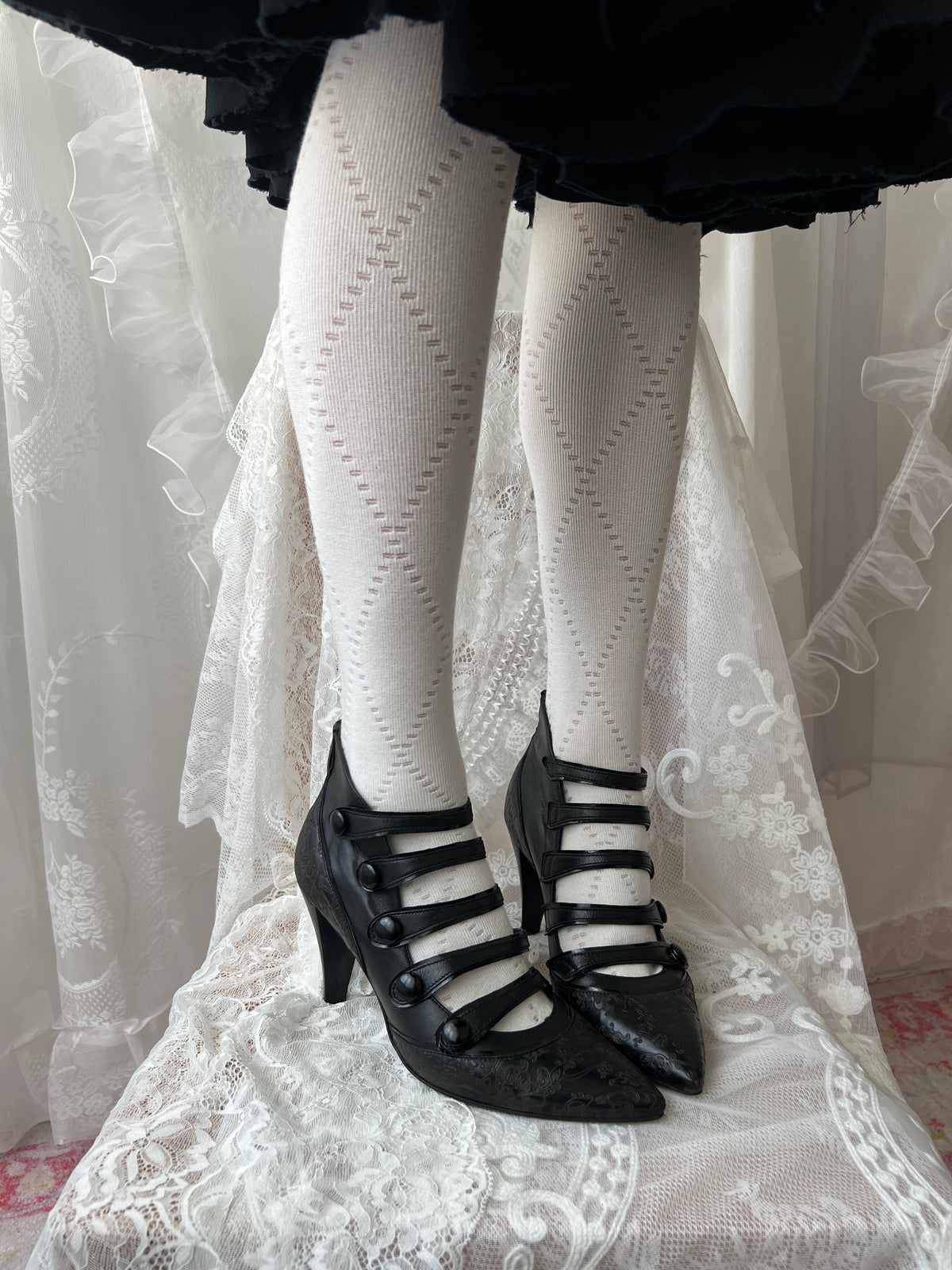 Black leather kitten heels with pointed toe and button details