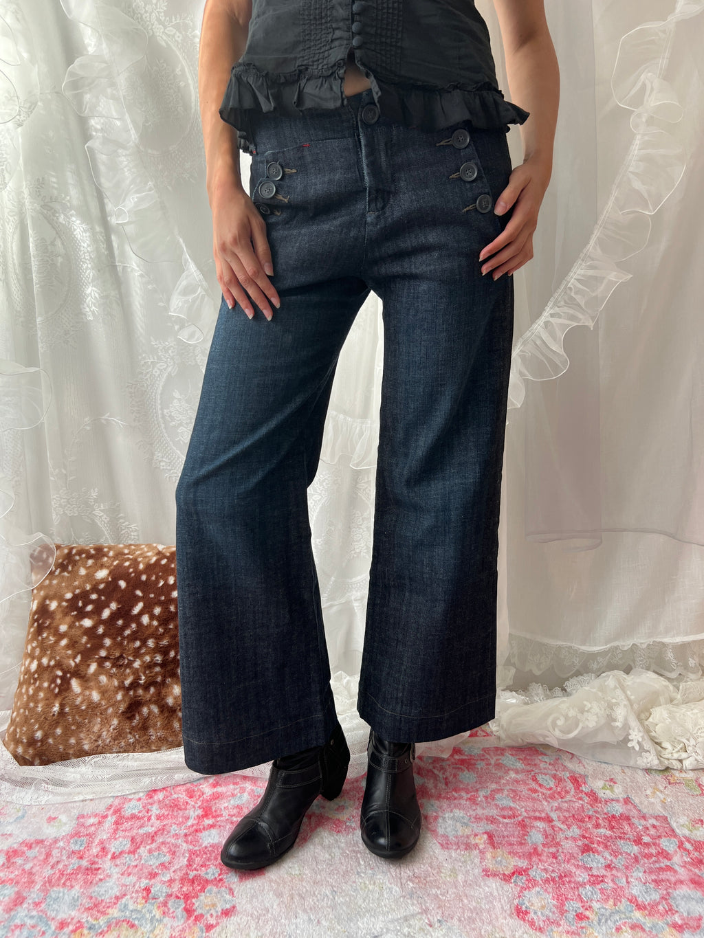 Dark wash denim jeans with button details and wide leg fit