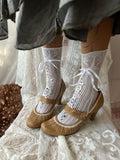 Tan Mary Jane heels with white lace trim and button detail