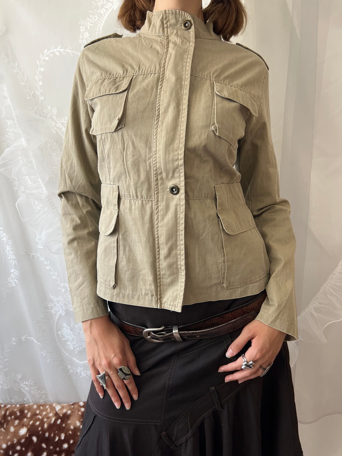 Khaki beige jacket with pockets, a zipper and a button-up front