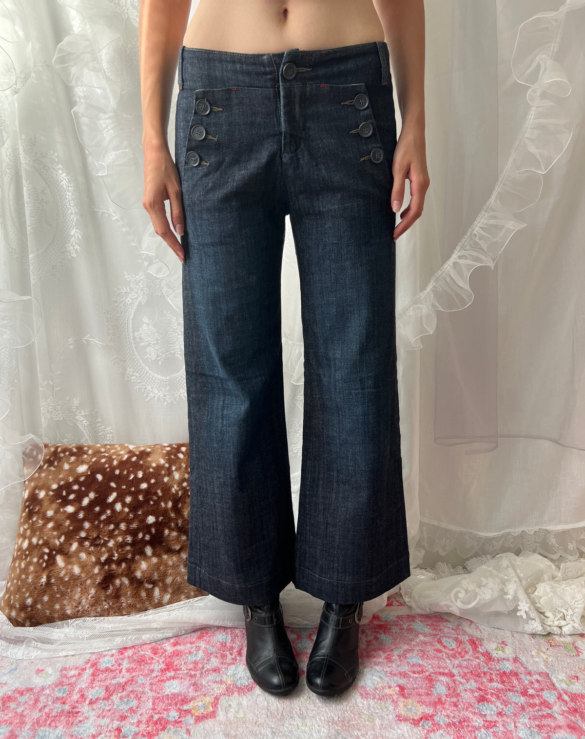 Dark wash denim jeans with button details and wide leg fit