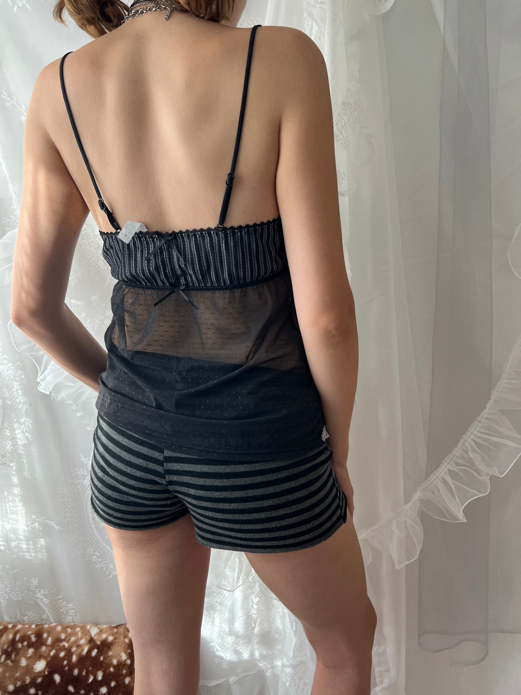 Black lace cami top with sheer mesh overlay and adjustable straps