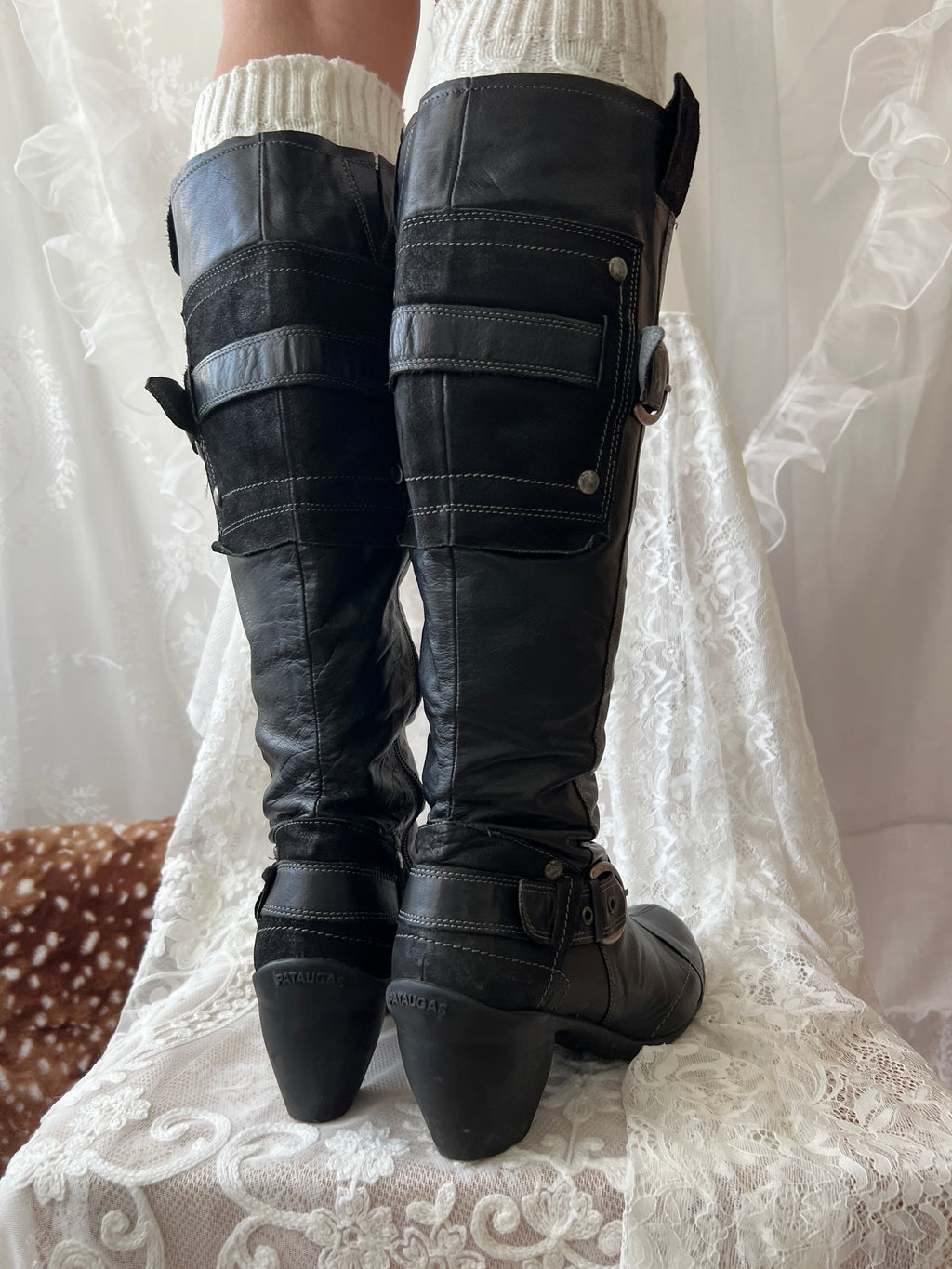 Black knee high boots with silver buckles