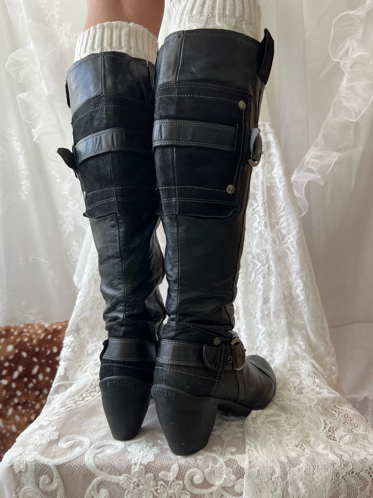 Black knee high boots with silver buckles
