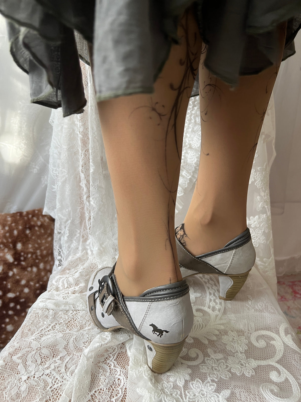 White Mustang heels with gray straps and buckles
