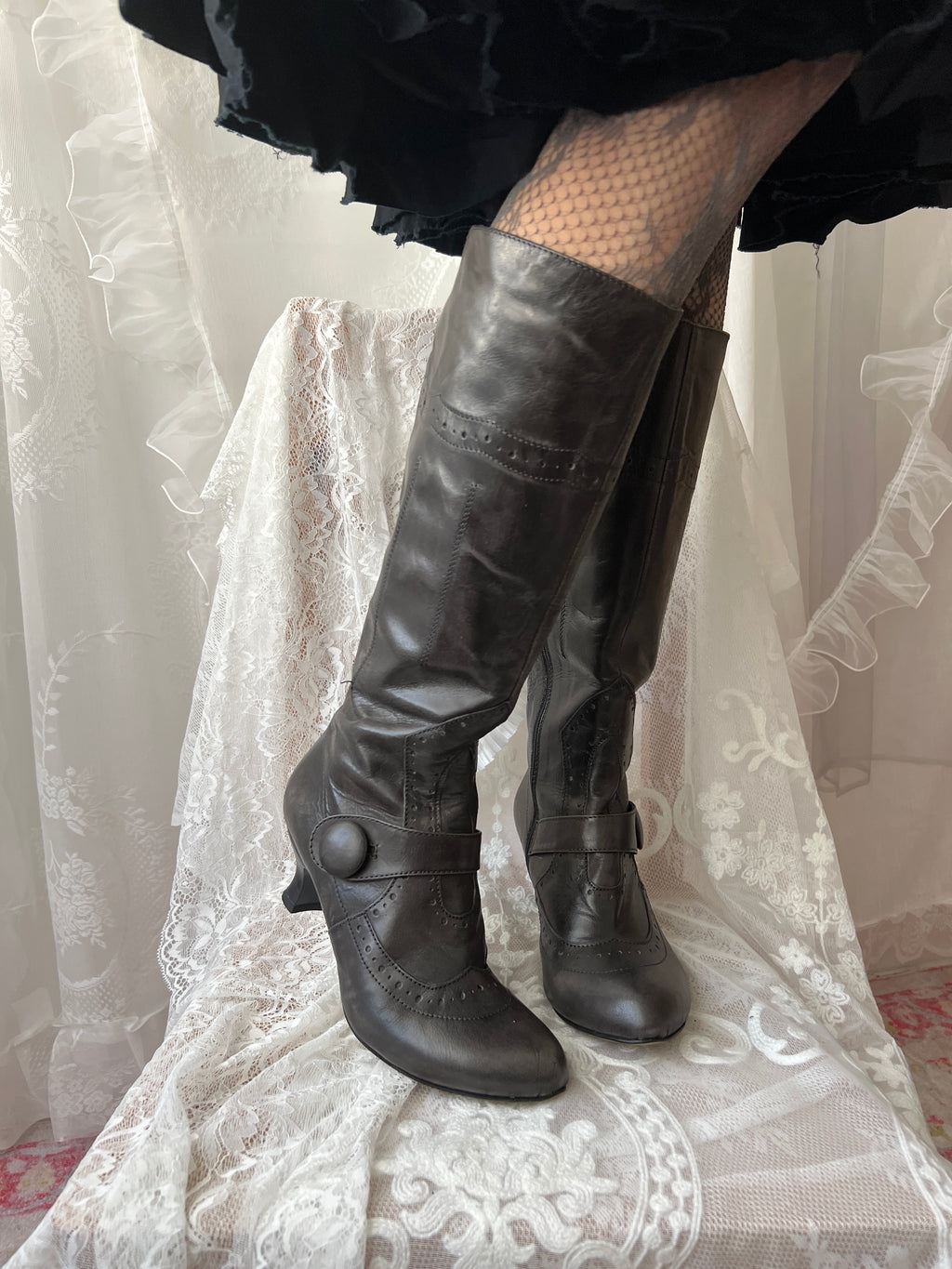 Black leather knee high boots with buckle detail