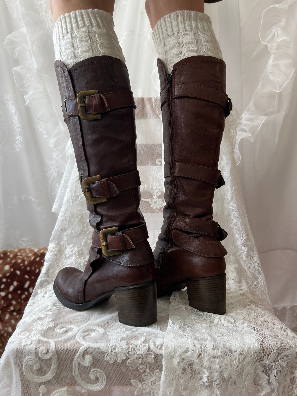 Brown knee high boots with buckle detail