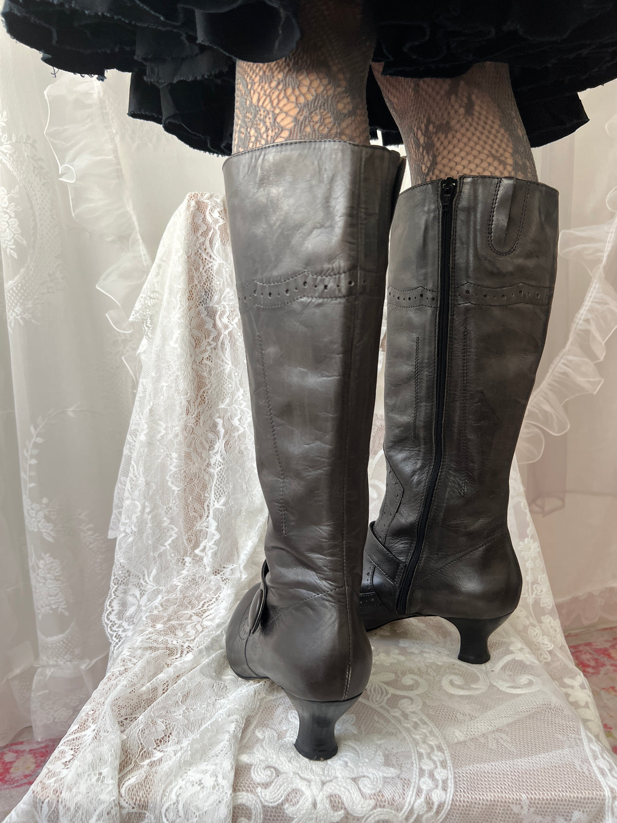 Black leather knee high boots with buckle detail