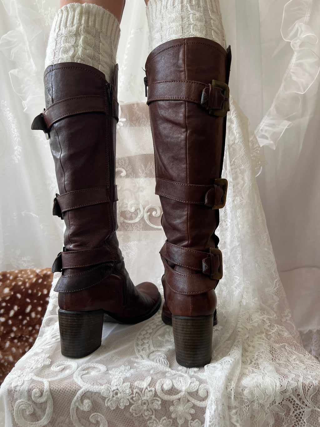Brown knee high boots with buckle detail
