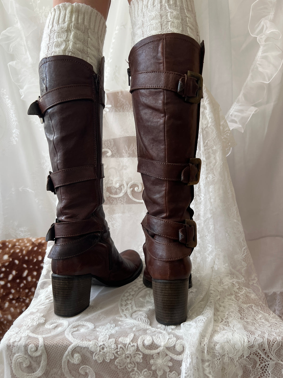 Brown knee high boots with buckle detail