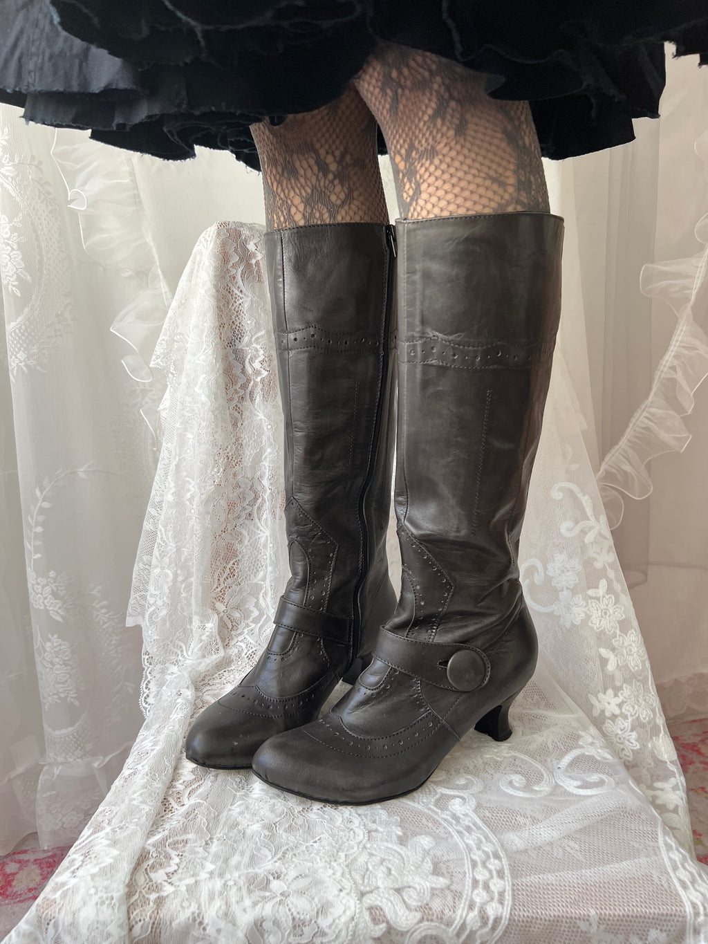 Black leather knee high boots with buckle detail