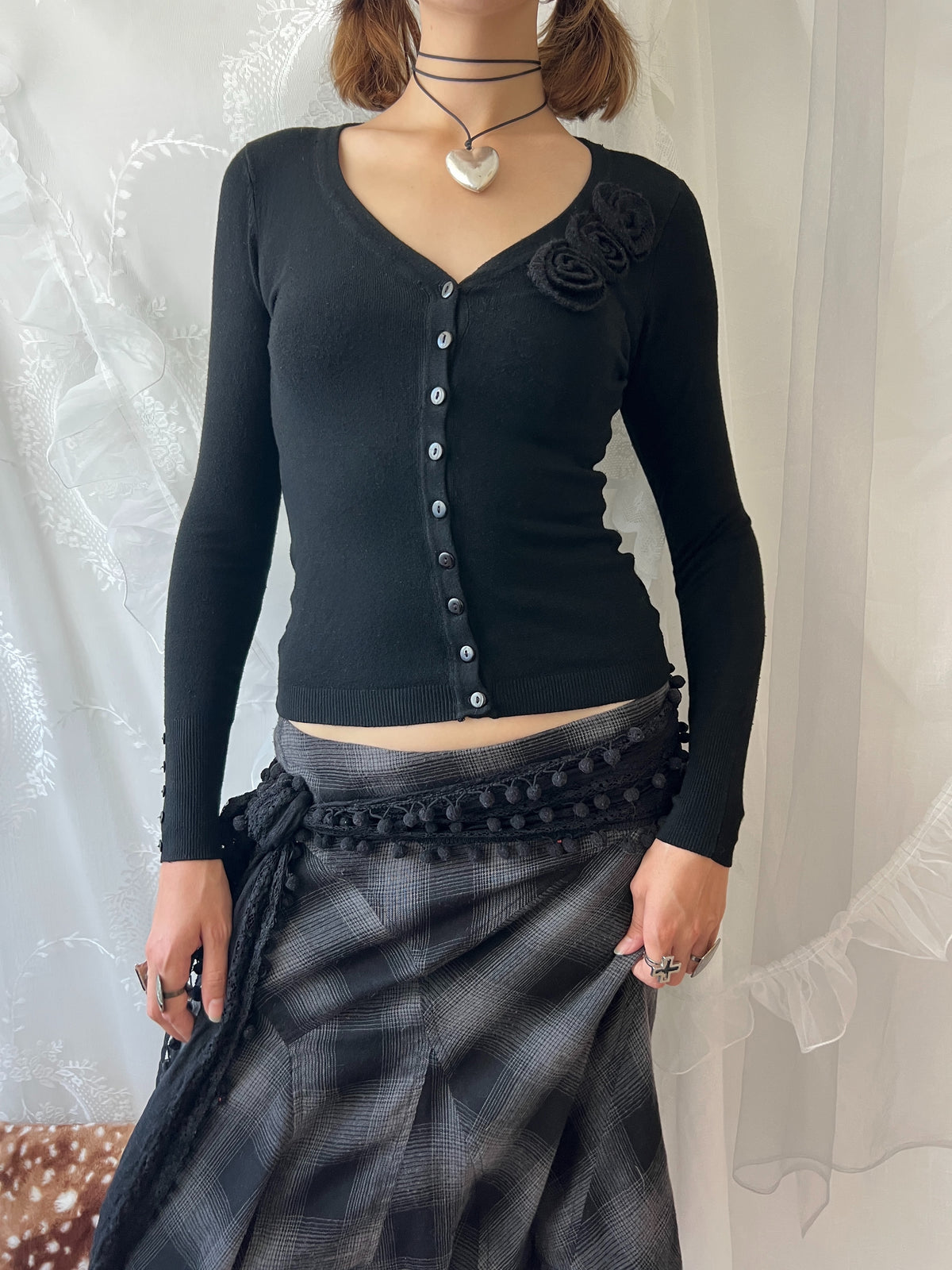 Black long sleeve top with button up front and flower detail