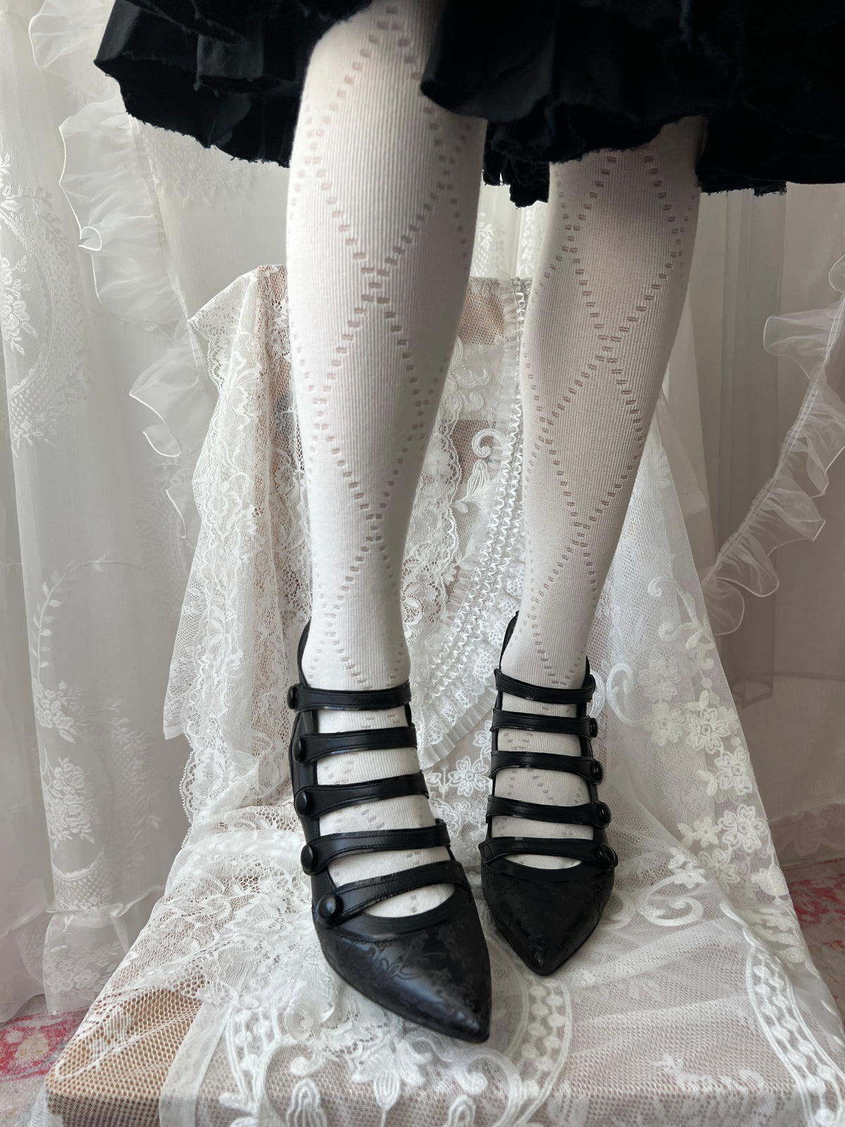 Black leather kitten heels with pointed toe and button details